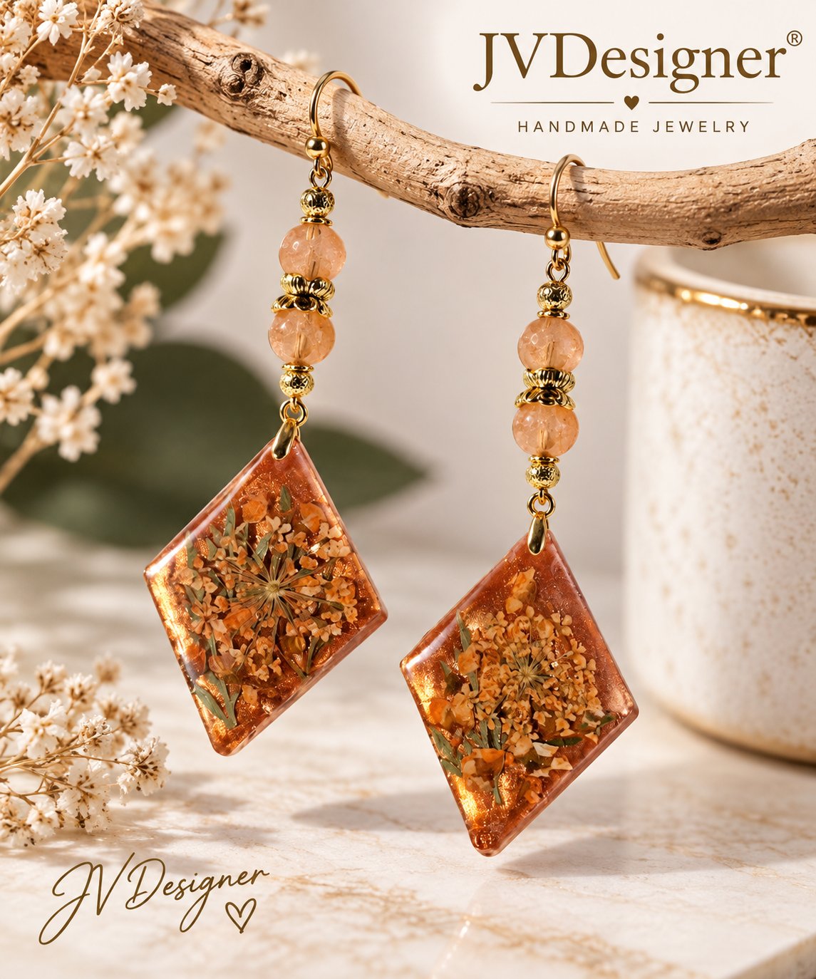 Amber dried-flower resin dangle earrings with antique gold beads hanging from a branch