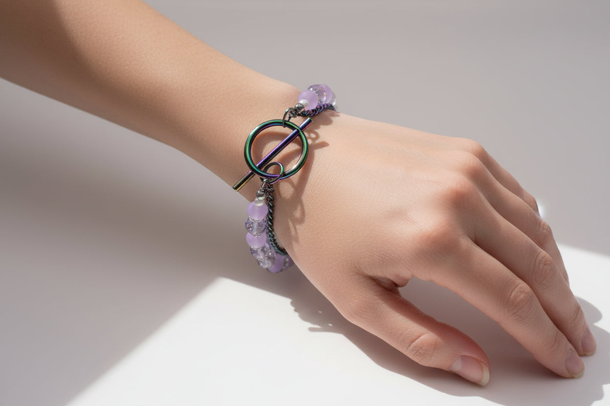 Bracelet with purple beads and a colorful clasp on a white background