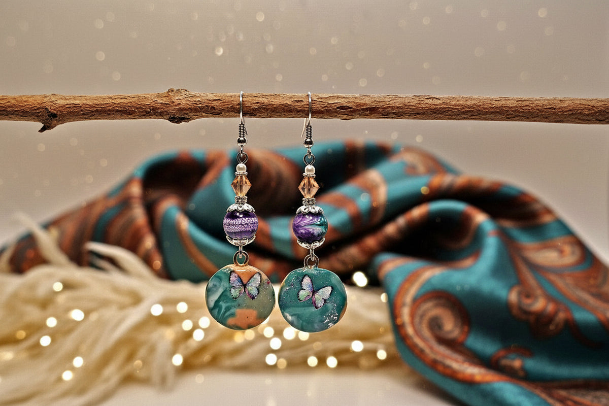 Pair of earrings with butterfly designs on a wooden stick against a bokeh background