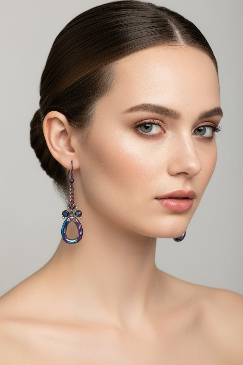 Pair of colorful earrings with chain and bead details on a white background