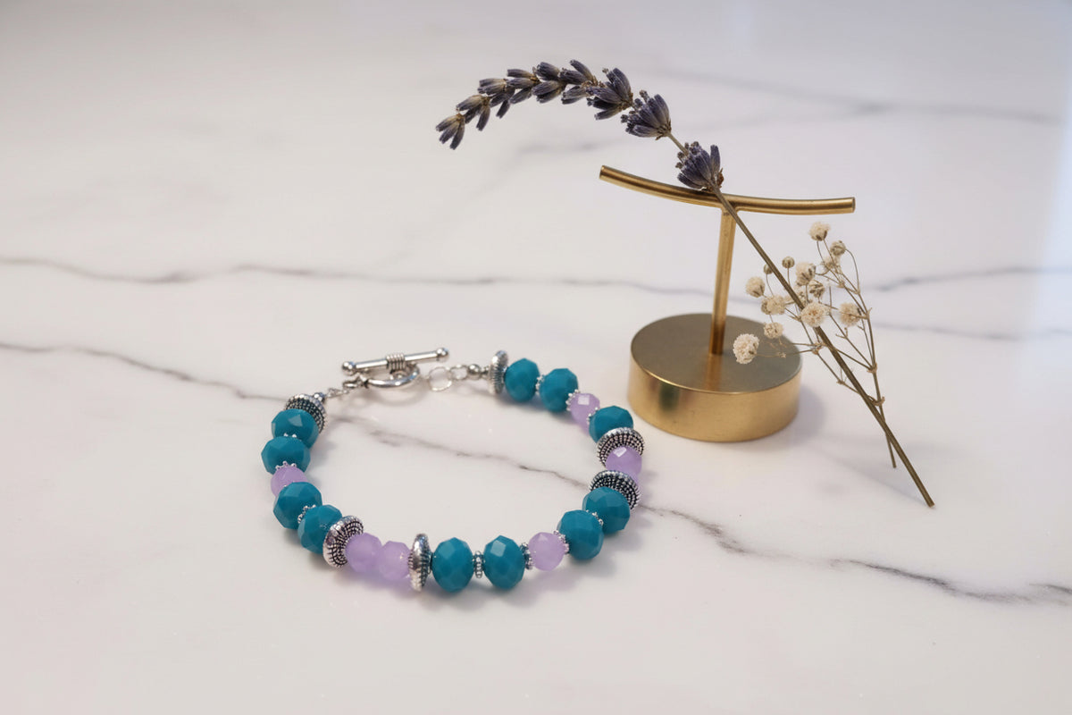 Bracelet with blue and purple beads on a light background