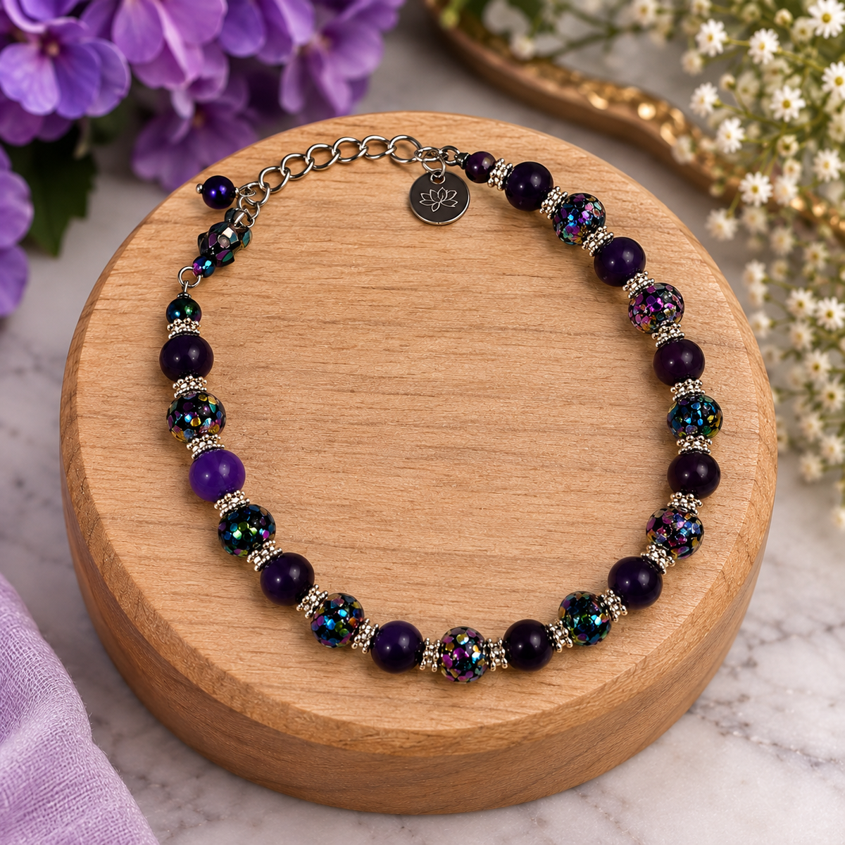 Purple beaded bracelet with iridescent crystal beads, silver accents and lotus charm