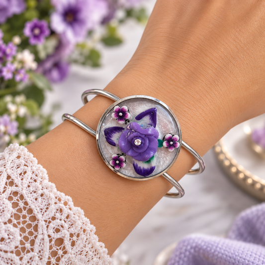 Purple flower bracelet with handmade clay resin cabochon on adjustable silver band, close-up view