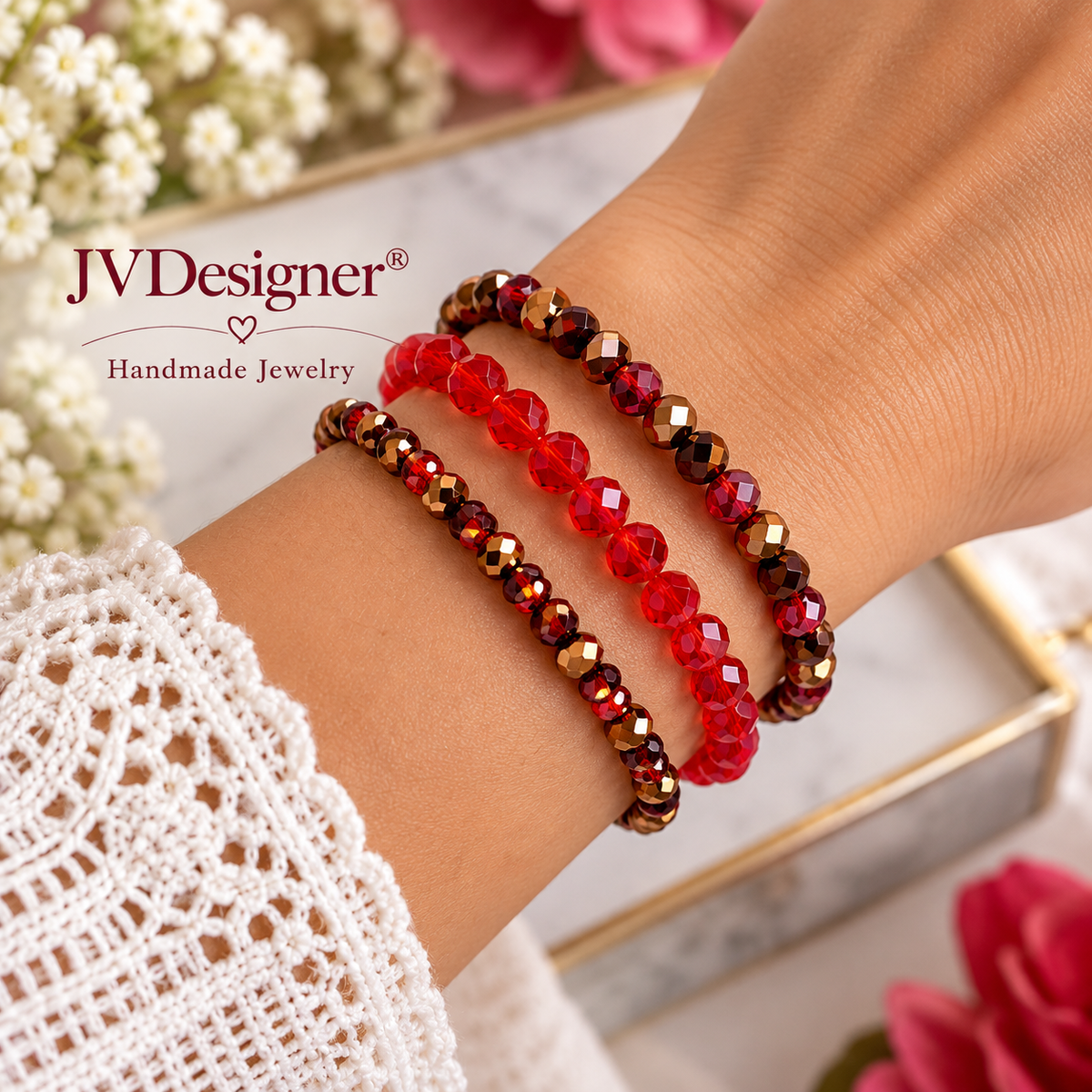 Three beaded stretch bracelets on a person's wrist, featuring red faceted beads and dark brown metallic beads. The brand logo 'JVDesigner Handmade Jewelry' is visible in the top left corner.