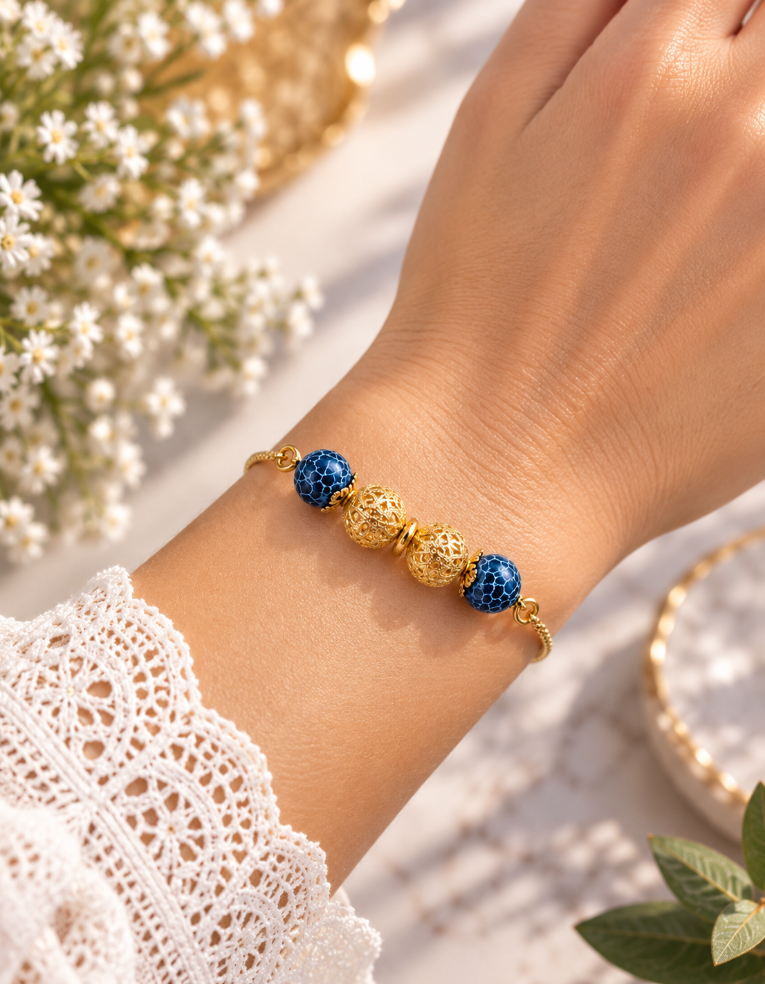 Gold plated blue bead bracelet with cobalt blue beads worn on wrist, close-up view