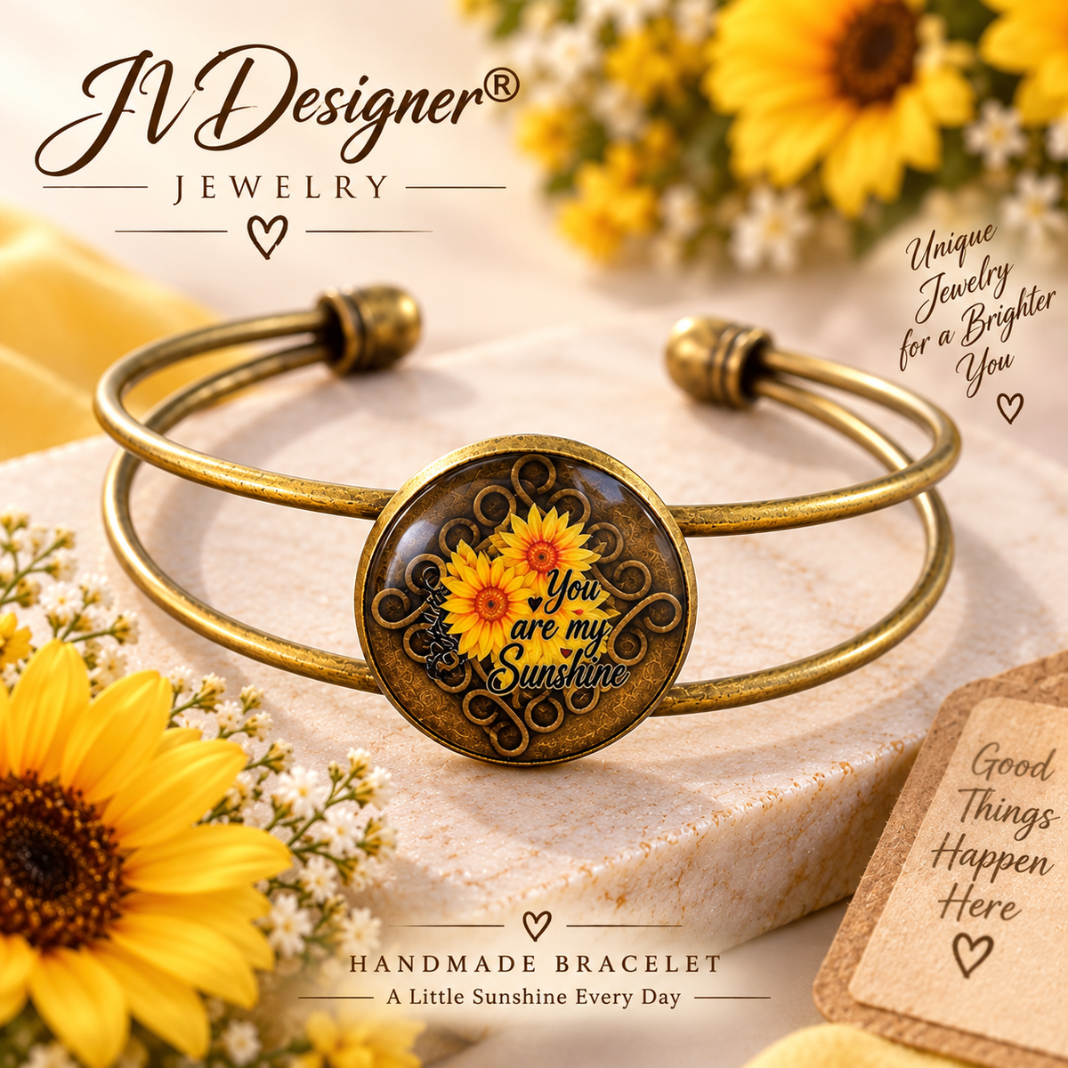 An antique gold-tone metal cuff bracelet with a round cabochon featuring yellow sunflowers and the text 'You are my Sunshine'. The bracelet is styled on a light stone block with sunflower props and decorative text overlays from 'JV Designer Jewelry'.