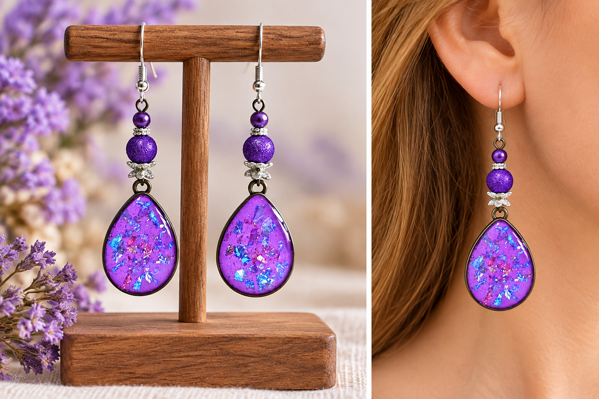 Purple resin dangle earrings with silver-tone hardware, shown hanging on a wooden display stand and worn on a model's ear. The earrings feature a teardrop-shaped purple resin drop filled with glitter, accented by purple beads and silver spacer rings.