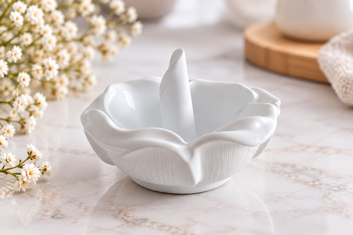White flower-shaped handmade resin ring dish holder on marble surface