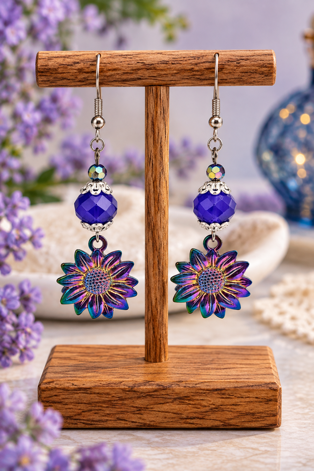 Royal blue sunflower earrings with ion plated flowers on wooden display stand
