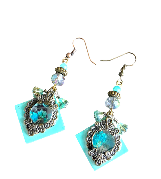 Antique bronze square earrings with turquoise resin centers and blue flowers