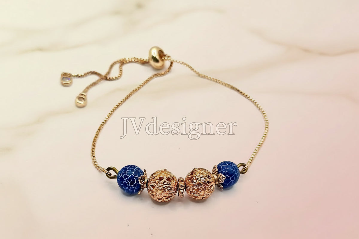 An adjustable gold bracelet with blue agate beads and antique gold filigree beads.