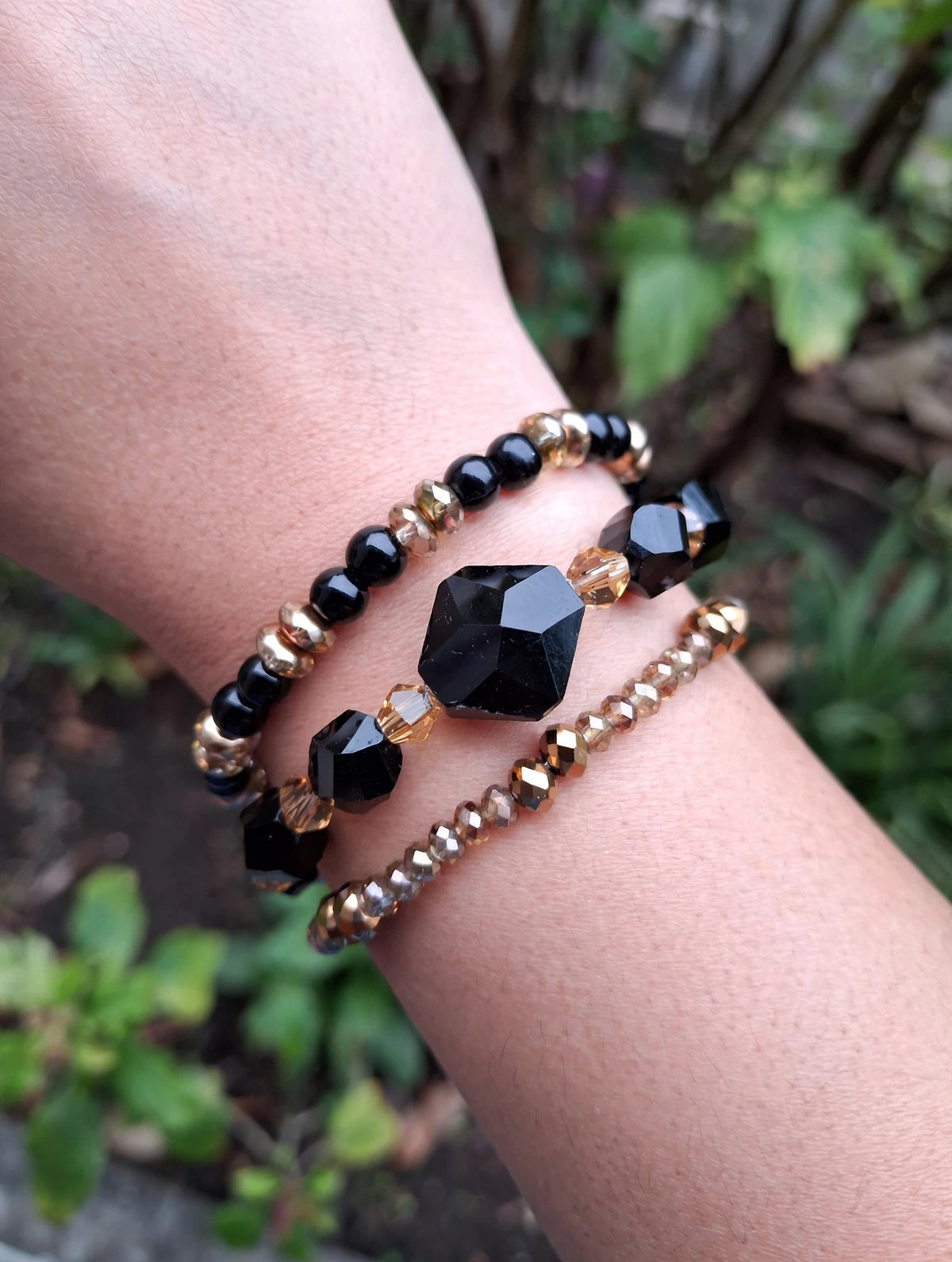 Midnight Gold glass bead bracelet set of 3 worn stacked on a wrist
