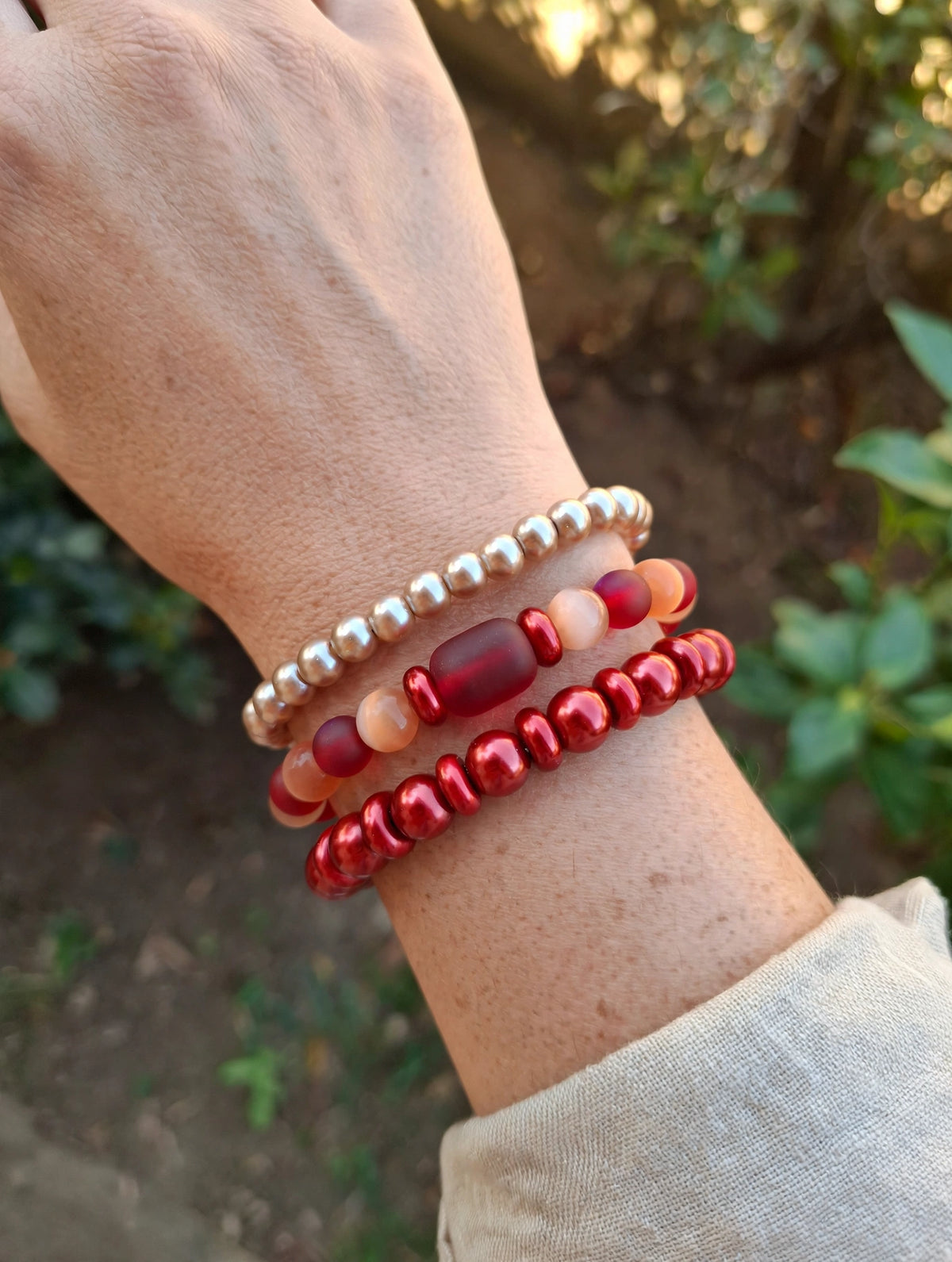 Scarlet Glow glass bead bracelet set of 3 worn stacked on a wrist