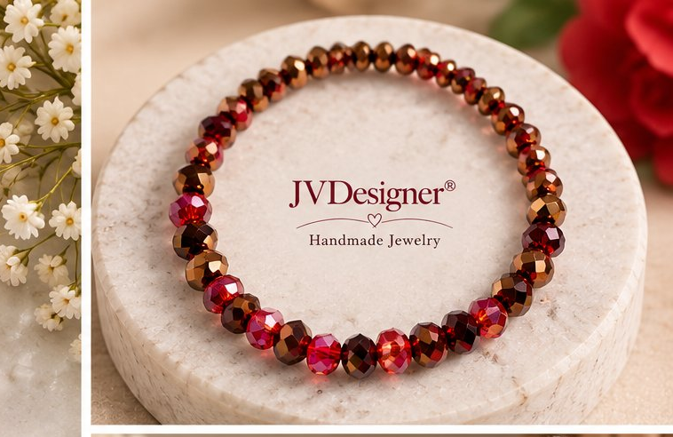 A beaded bracelet with faceted brown and red beads, displayed on a round white marble pedestal. The brand name 'JVDesigner Handmade Jewelry' is printed on the pedestal.